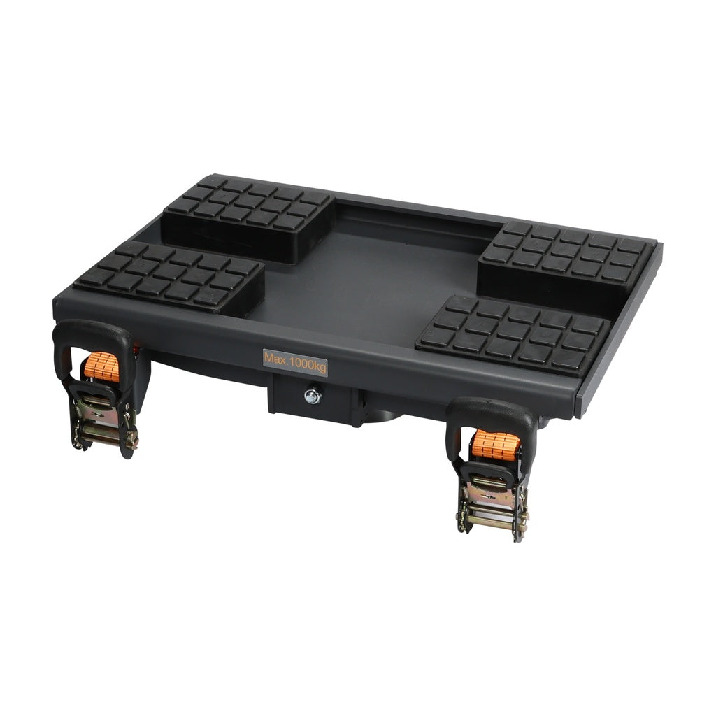 A black heavy-duty equipment with four cushioned support pads on top and two orange ratchet straps with hooks on the sides for securing loads